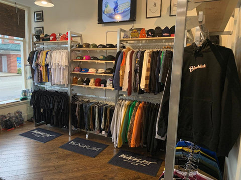 Apparel display of shirts, hats, and accessories at Blacklist